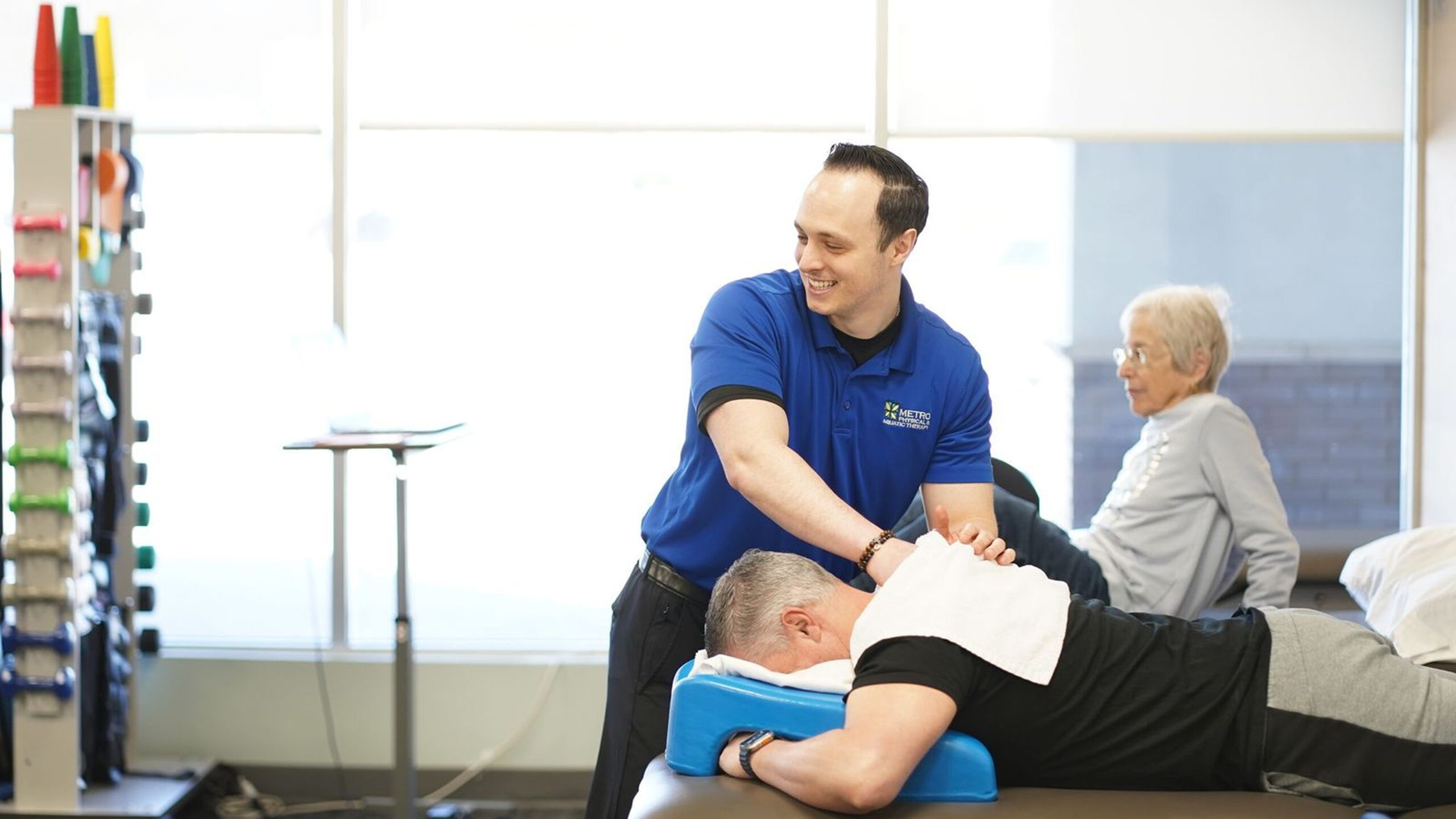Therapist treating a patient on a table