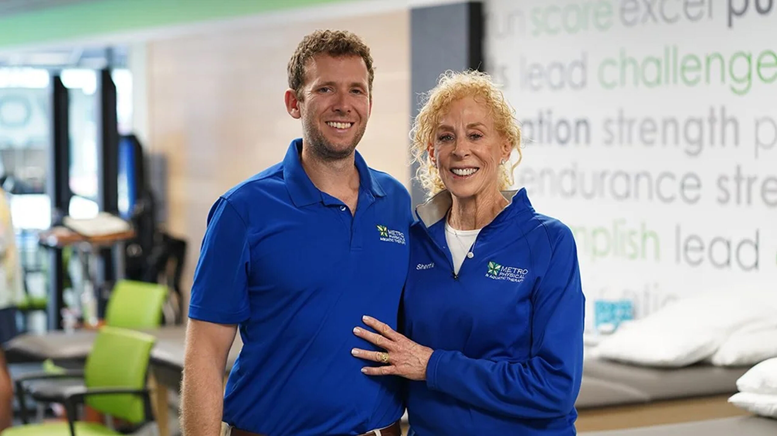 Two Metro Physical Therapy team members in blue polos